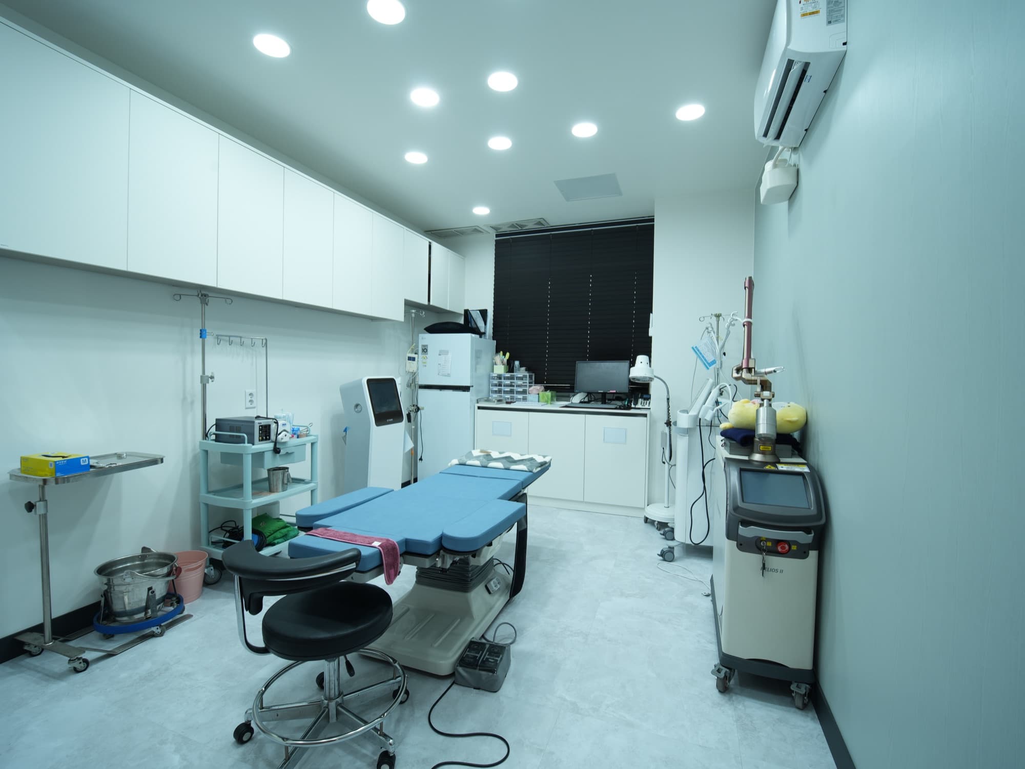 Clean, brightly lit treatment room equipped with advanced laser and skin-care devices